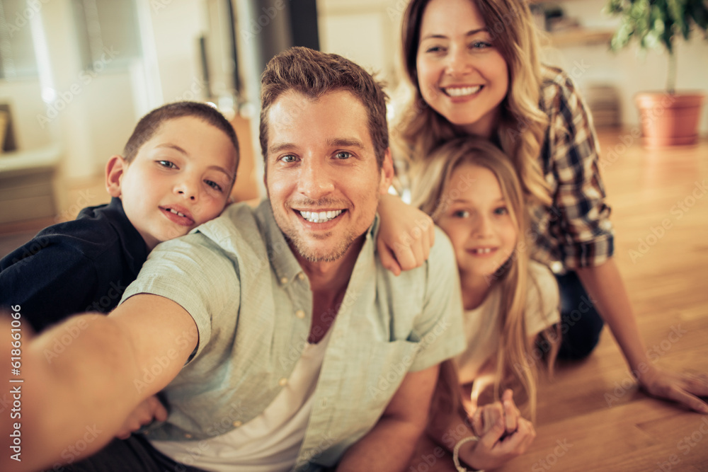 Young family taking a selfie in the living room at home Young family taking a selfie in the living room at home
