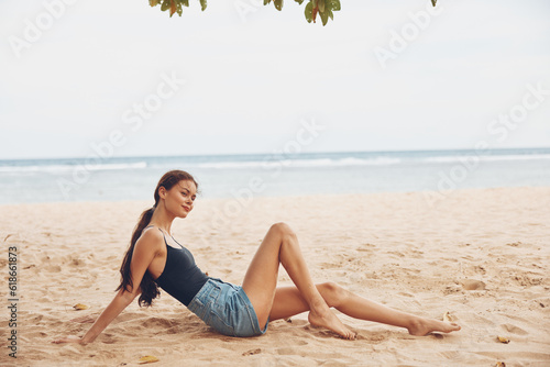 beach woman sitting sea smile view nature vacation sand freedom travel back