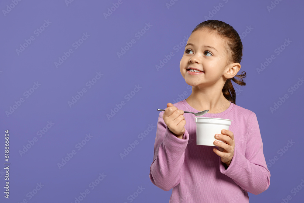 Girl with tasty yogurt on violet background, space for text Girl with tasty yogurt on violet background, space for text