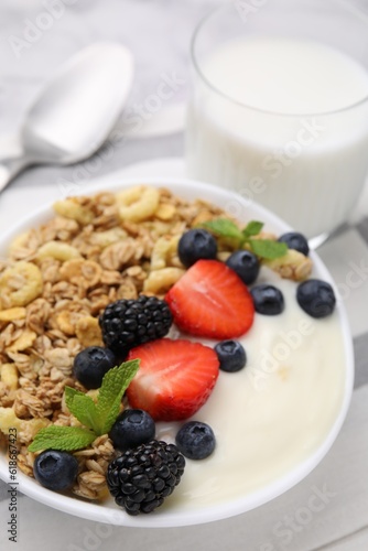 Tasty oatmeal  yogurt and fresh berries in bowl on table  closeup. Healthy breakfast