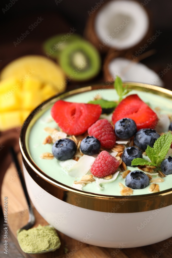Tasty matcha smoothie bowl served with berries and oatmeal on table, closeup. Healthy breakfast Tasty matcha smoothie bowl served with berries and oatmeal on table, closeup. Healthy breakfast