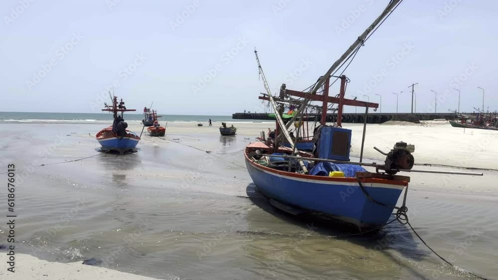 Fishing boats beached on the sand at low tied in Thailand Fishing boats beached on the sand at low tied in Thailand