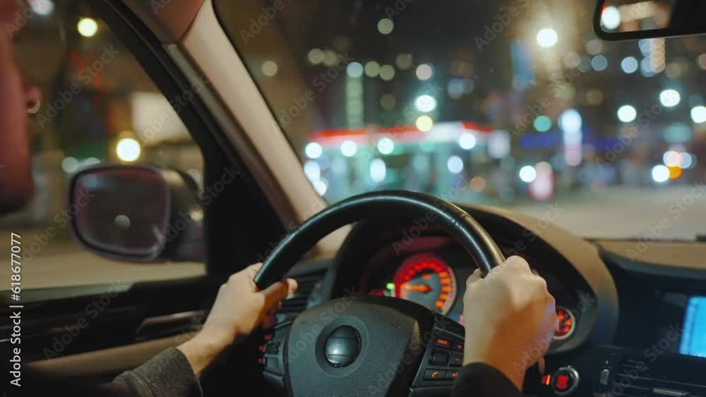 Man driving car through the streets of night city. Man driving car through the streets of night city.