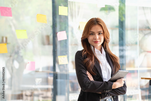 Portrait of a woman business owner showing a happy smiling face as he has successfully invested in her business using tablets and financial budget documents at work. Free Download Portrait of a woman business owner showing a happy smiling face as he has successfully invested in her business using tablets and financial budget documents at work. - GFXLoad