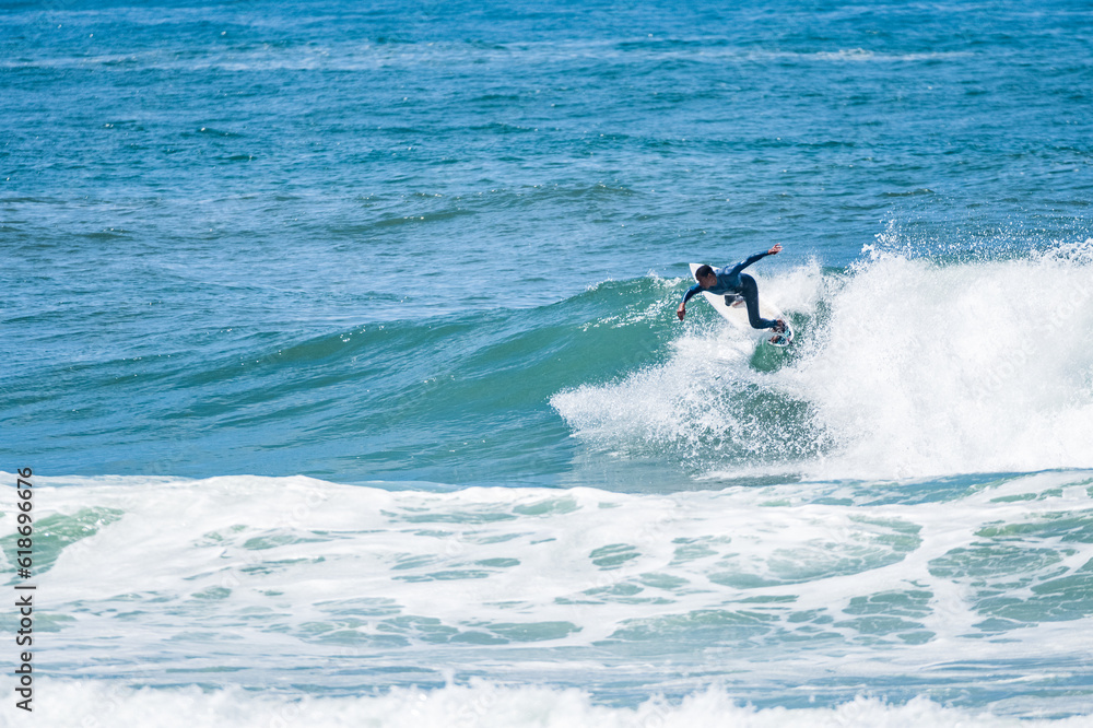 Young athletic surfer rides the wave Young athletic surfer rides the wave
