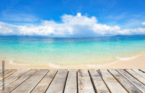 Wooden table top on blur blue sea background in summer season.For montage product display or design key visual layout.View of copy space.