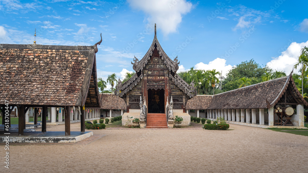 The beautiful architecture of Wat Ton Kwen or Wat Inthrawat Temple the ancient and prominent old wooden temple with blue sky is a famous place and travel destination in Chiang Mai Northern Thailand.