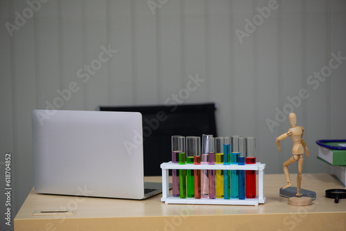 The work desk featured a laptop, a chemistry tube, and a mannequin, reflecting a dynamic blend of technology, scientific experimentation, and creativity. © Digital Art Studio