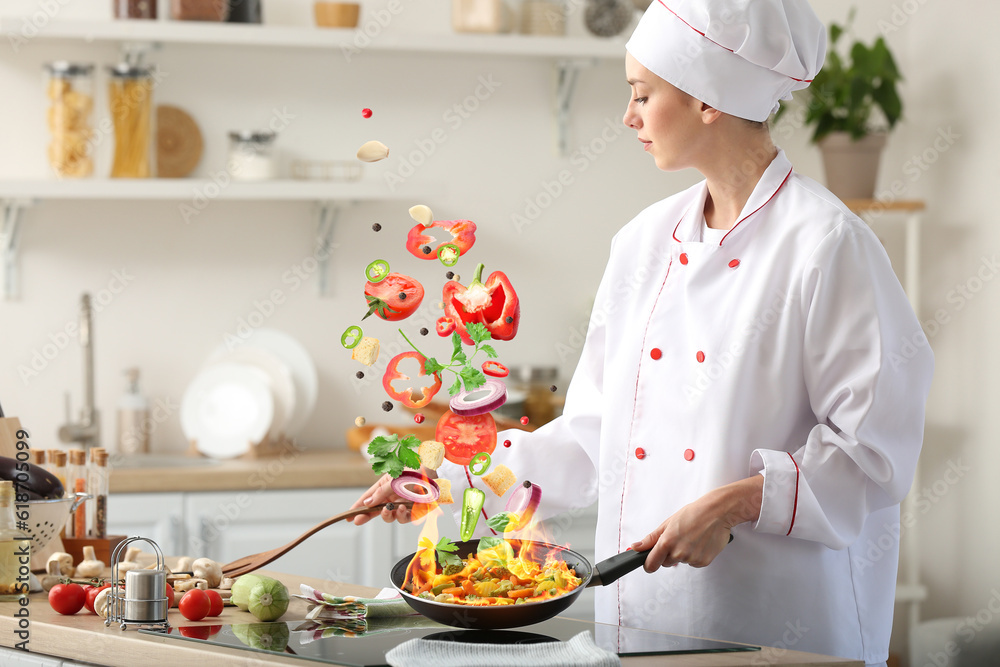Female chef frying vegetables in kitchen Female chef frying vegetables in kitchen