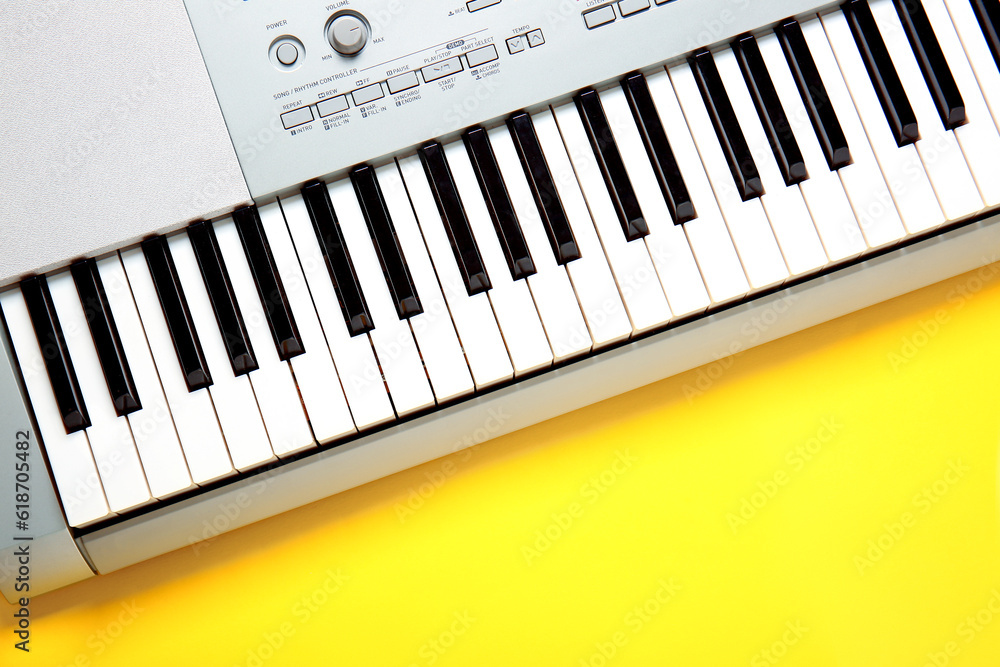 Modern synthesizer keyboard on yellow background Modern synthesizer keyboard on yellow background