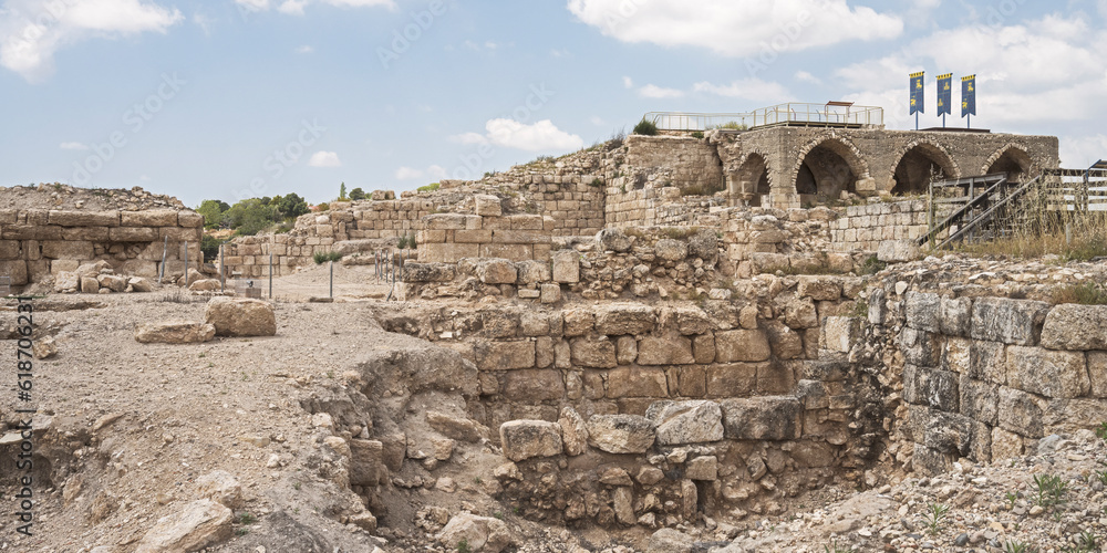 panorama of ancient ruins at Beit Guvrin Park in Israel including Roman, Byzantine and Crusader buildings with a partly cloudy sky in the background