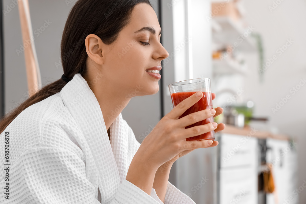 Young woman with glass of vegetable juice in kitchen, closeup Young woman with glass of vegetable juice in kitchen, closeup