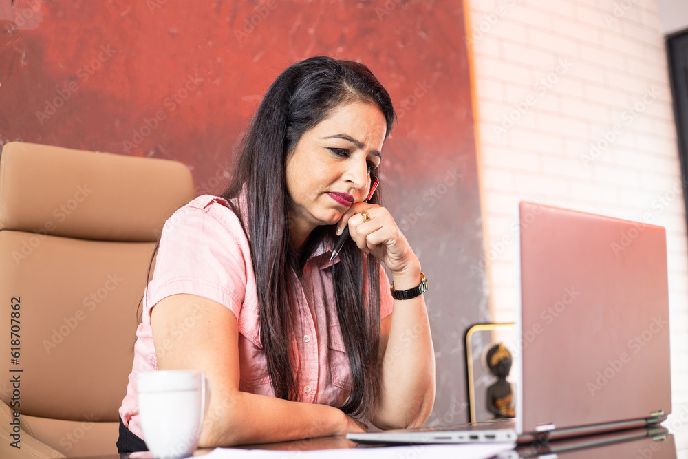 Young indian businesswoman working on laptop computer in office. Young indian businesswoman working on laptop computer in office.