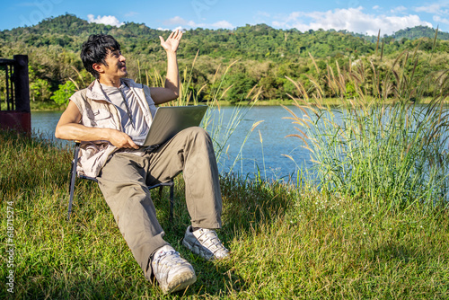 Принти на полотні Young travel man relax and enjoy talking calling on video on laptop, using lapto