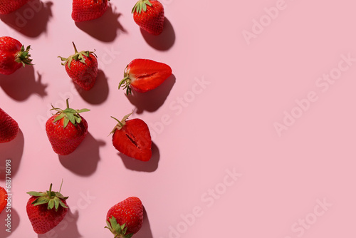 Many fresh strawberries on pink background