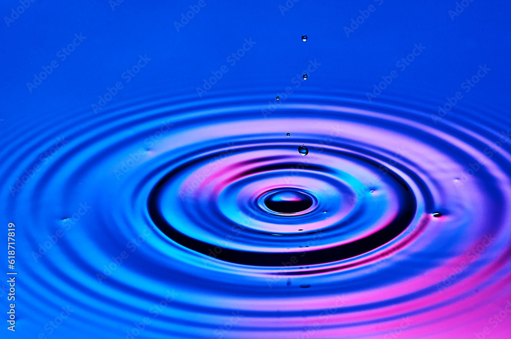 a drop of water falling into the water and creating waves a drop of water falling into the water and creating waves