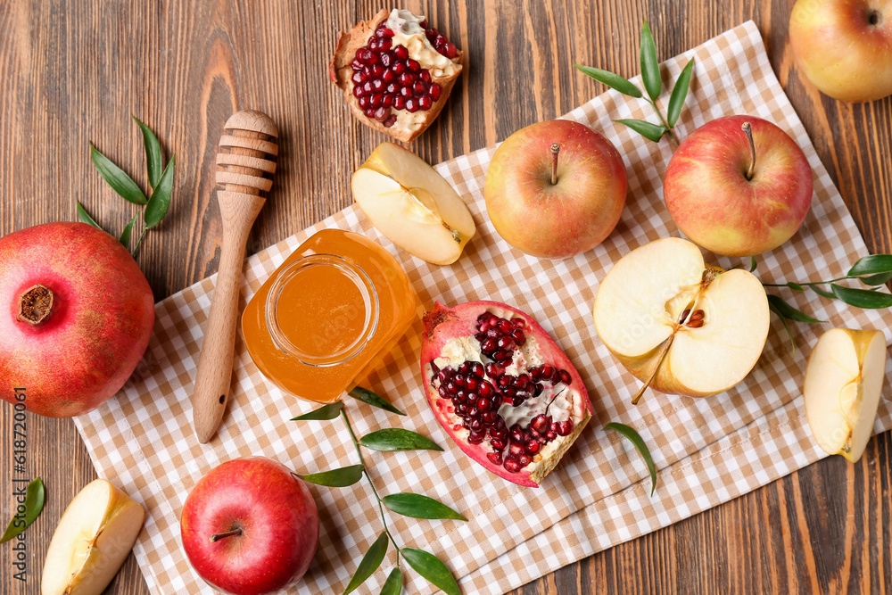 Composition with ripe fruits and honey on wooden background, closeup. Rosh hashanah (Jewish New Year) celebration