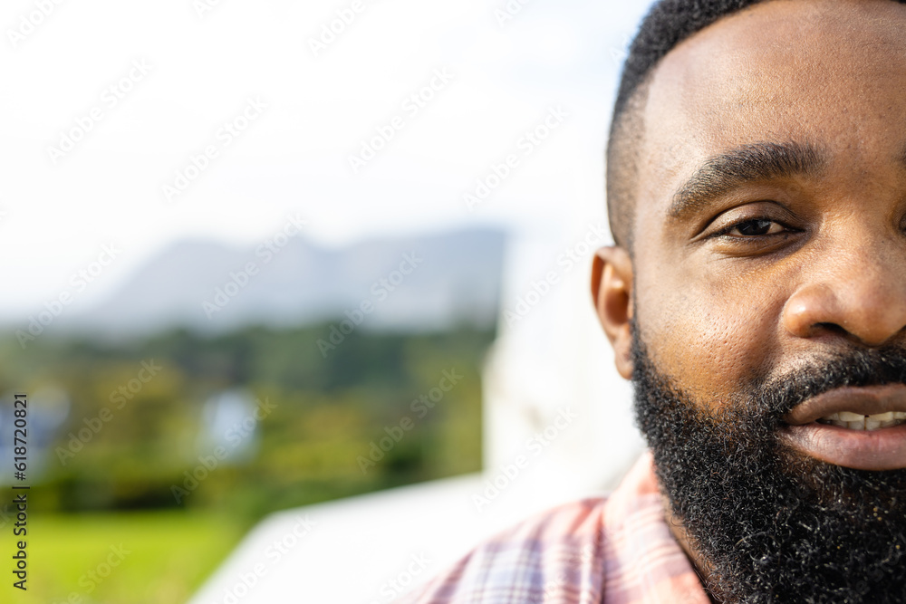 Half portrait of happy african american man on sunny terrace with copy space Half portrait of happy african american man on sunny terrace with copy space