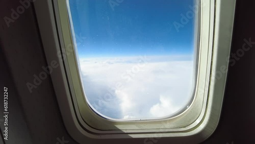 Aircraft window with blue skyes and clouds photo