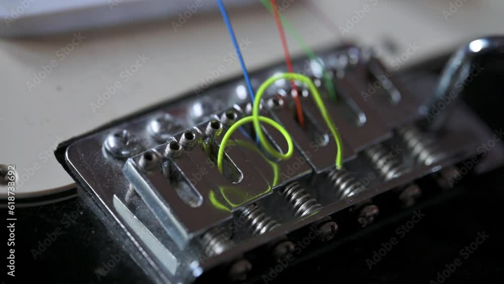 Man removing old strings on electric guitar. Guitar service concept. 4k video footage UHD 3840x2160 Man removing old strings on electric guitar. Guitar service concept. 4k video footage UHD 3840x2160