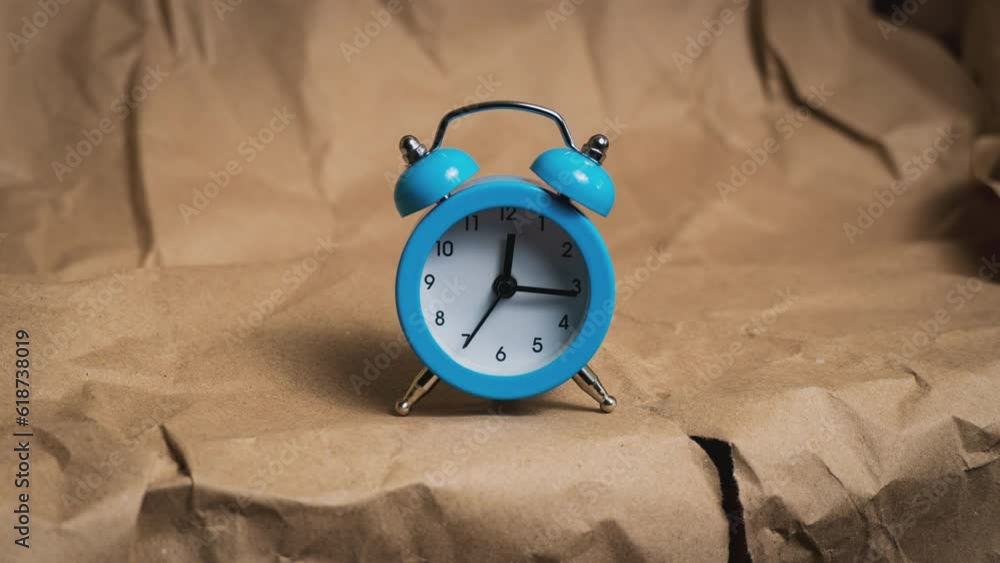 Hands of the classic alarm clock count the time. Time is running fast