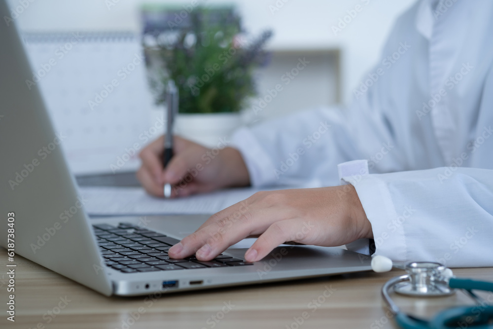 Medical technology concept. Doctor working with computer and stethoscope in modern office.. Medical technology concept. Doctor working with computer and stethoscope in modern office..