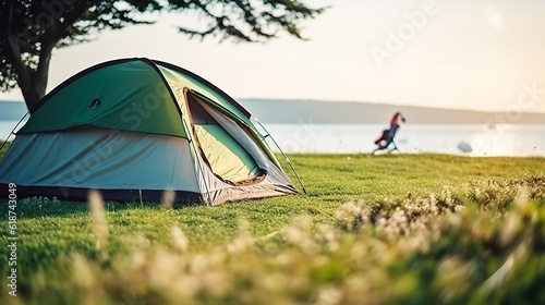 Wallpaper Mural Selective focused on Lawn or green grass ground of camping ground near the sea beach. with camping tent in the background Torontodigital.ca
