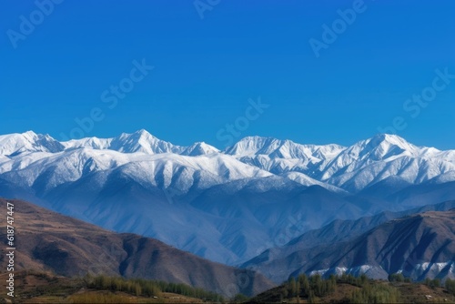 majestic mountain range  with snow-capped peaks and blue skies  created with generative ai