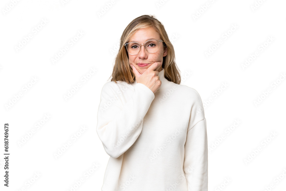 Young blonde woman over isolated background having doubts Young blonde woman over isolated background having doubts