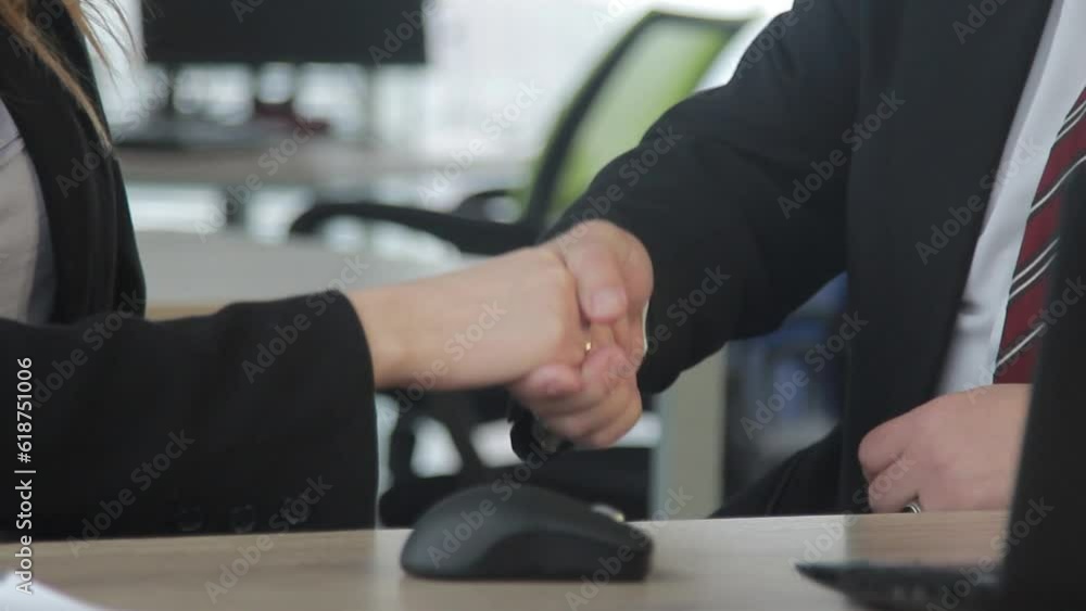 Business people shaking hands over a Desk. Office workers in business clothes. Travel on the slider in motion Business people shaking hands over a Desk. Office workers in business clothes. Travel on the slider in motion