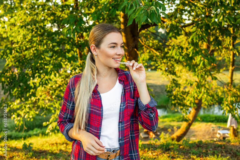 Young beautiful woman wearing red shirt over holding an invisible aligner. Dental healthcare and confidence concept. Places for text Young beautiful woman wearing red shirt over holding an invisible aligner. Dental healthcare and confidence concept. Places for text