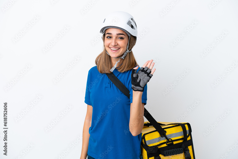 Young caucasian woman with thermal backpack isolated on white background saluting with hand with happy expression Young caucasian woman with thermal backpack isolated on white background saluting with hand with happy expression