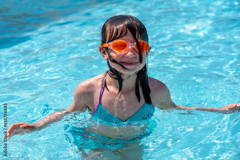 Portrait of young beautiful attractive girl learn to swimming in the waterpool