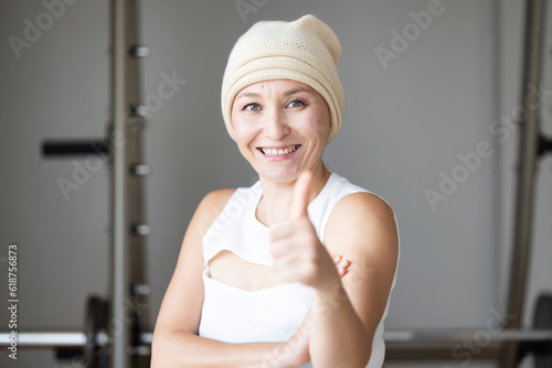 Thriving Beyond Cancer, Portrait of a Resilient and healthy Caucasian Woman showing thumb up gesture. Embodying Courage and Hope in the Face of Challenges