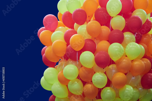 Bright red and orange balloons on a dark background