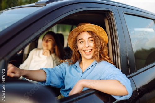 Two Young woman is resting and enjoying the trip in the car Automobile journey, traveling, lifestyle concept. Car sharing. © maxbelchenko