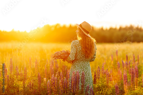 Beautiful woman in style dress on blooming fragrant lavender fields. Nature, vacation, relax and lifestyle