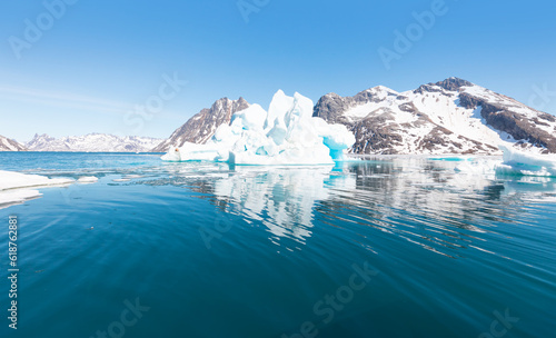 Arctic landscape of Greenland in Summer. Beautiful view of mountains with Snowy peaks and iceberg