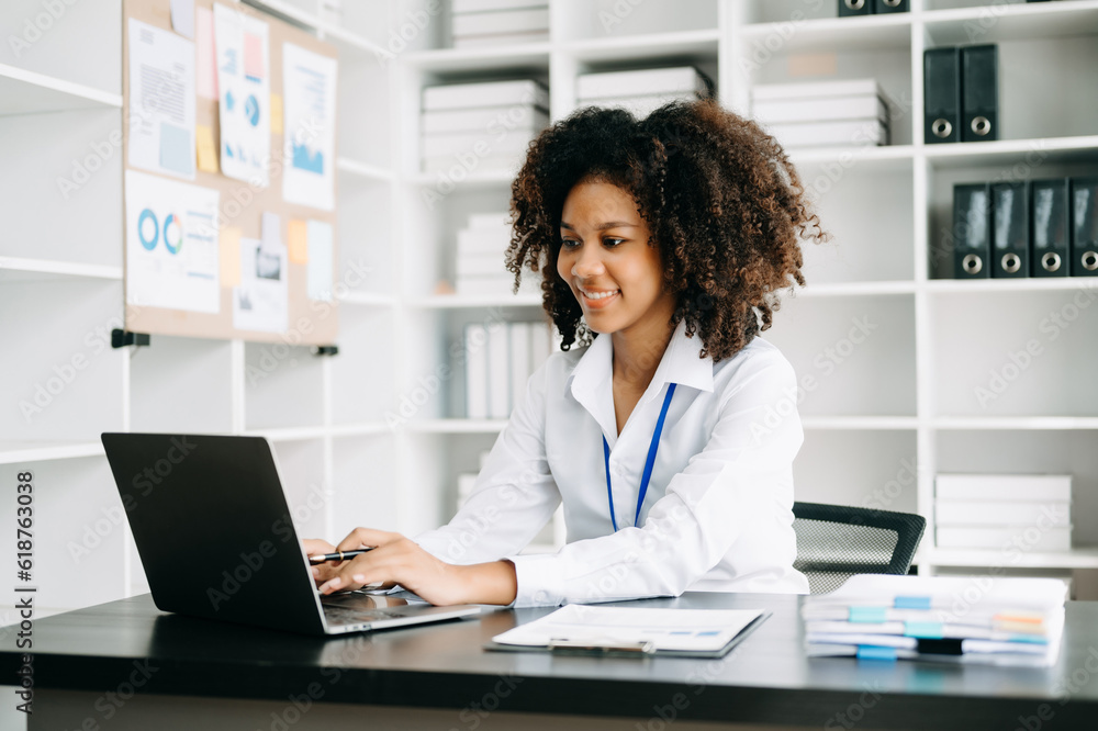 Business woman using tablet and laptop for doing math finance on an office desk, tax, report, accounting, statistics, and analytical research concept in office Business woman using tablet and laptop for doing math finance on an office desk, tax, report, accounting, statistics, and analytical research concept in office