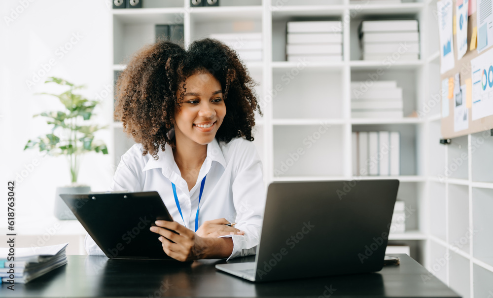 Business woman using tablet and laptop for doing math finance on an office desk, tax, report, accounting, statistics, and analytical research concept in office Business woman using tablet and laptop for doing math finance on an office desk, tax, report, accounting, statistics, and analytical research concept in office