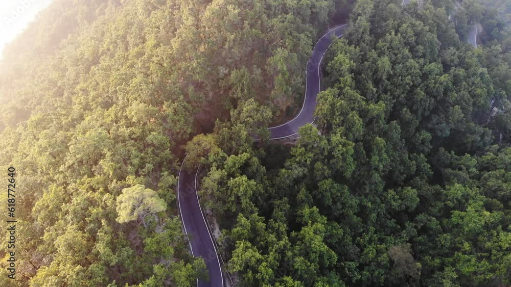 High quality 4K aerial video of taken with a drone flying over the roads amidst the green forest. High quality 4K aerial video of taken with a drone flying over the roads amidst the green forest.