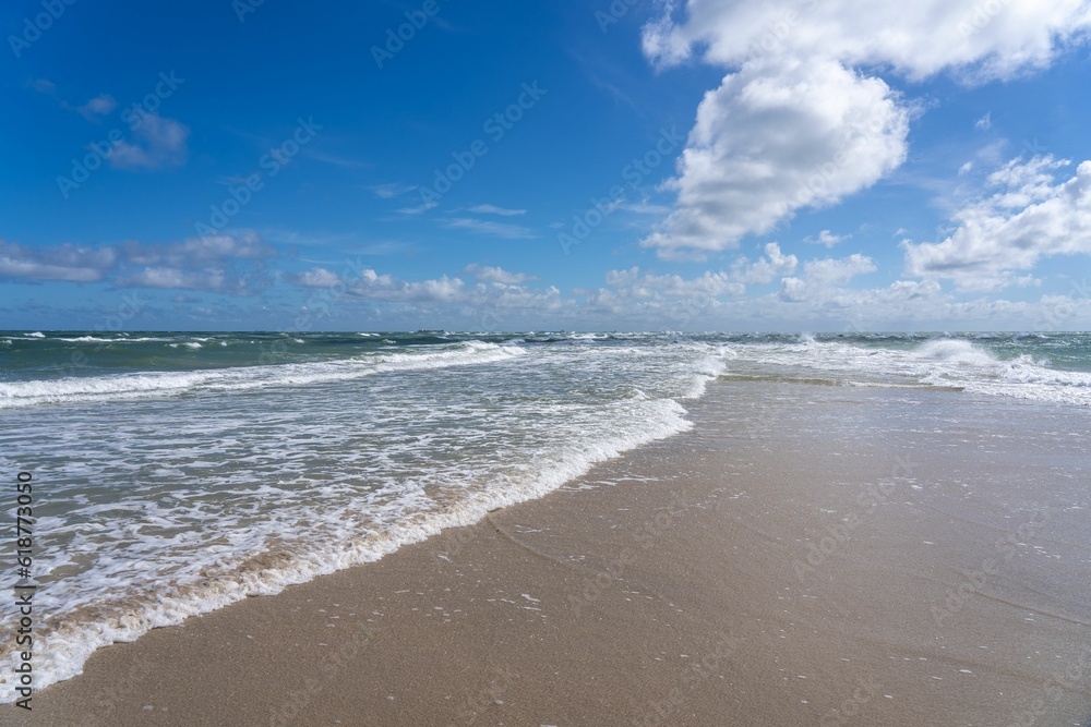 Obraz premium Pristine beach with white sand and azure blue ocean water in the background in Denmark.