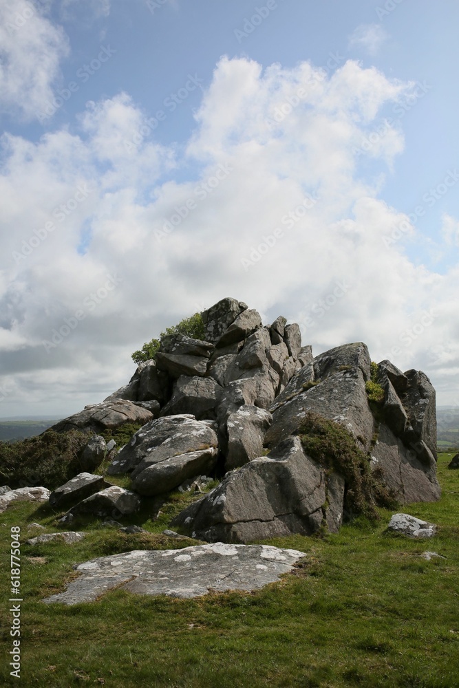 Scenic view of a hill of rocks under cloudy blue sky Scenic view of a hill of rocks under cloudy blue sky