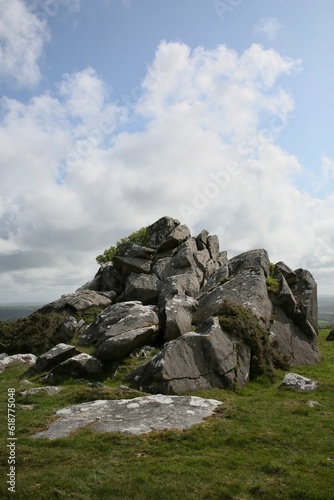 Scenic view of a hill of rocks under cloudy blue sky © Via19/Wirestock Creators