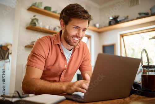 Networking, laptop and remote work, happy man at kitchen counter with email, social media post or research for job. Technology, writer or freelancer on internet typing blog or online article at home.
