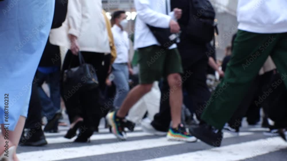 SHIBUYA, TOKYO, JAPAN - MAY 2023 : Crowd of people walking at Shibuya crossing in daytime. Busy downtown area in Tokyo. Japanese people, urban city life and metropolis concept video. Slow motion shot. SHIBUYA, TOKYO, JAPAN - MAY 2023 : Crowd of people walking at Shibuya crossing in daytime. Busy downtown area in Tokyo. Japanese people, urban city life and metropolis concept video. Slow motion shot.
