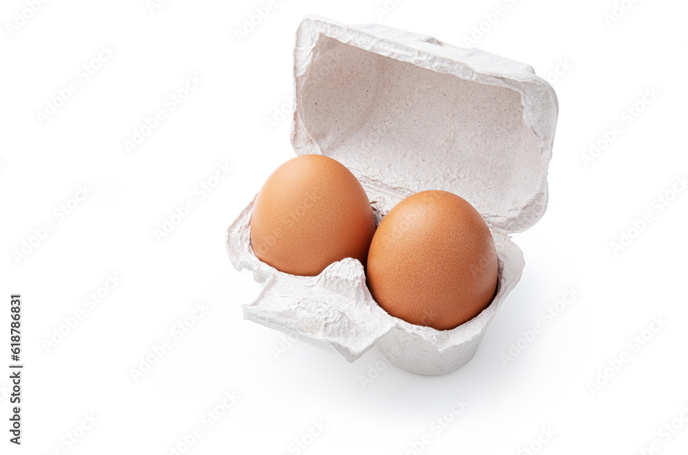 Two fresh eggs in their container, isolated on white background, close-up. Two fresh eggs in their container, isolated on white background, close-up.
