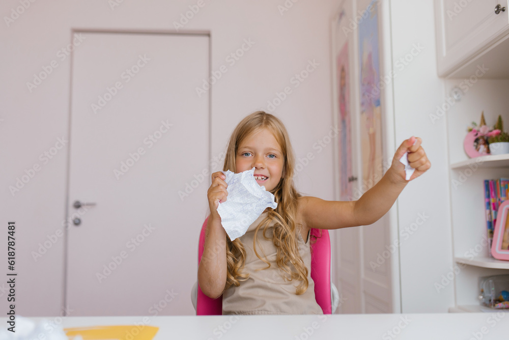 Kid Ripping Up Homework Schoolgirl tears up a sheet of a school notebook because of an ...