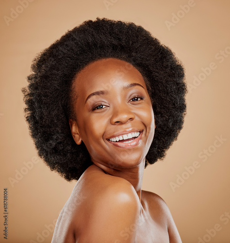 Happy, skincare and portrait of a black woman with a glow from dermatology, salon or wellness. Smile, beauty and face of an African model with care for skin isolated on a brown background in a studio