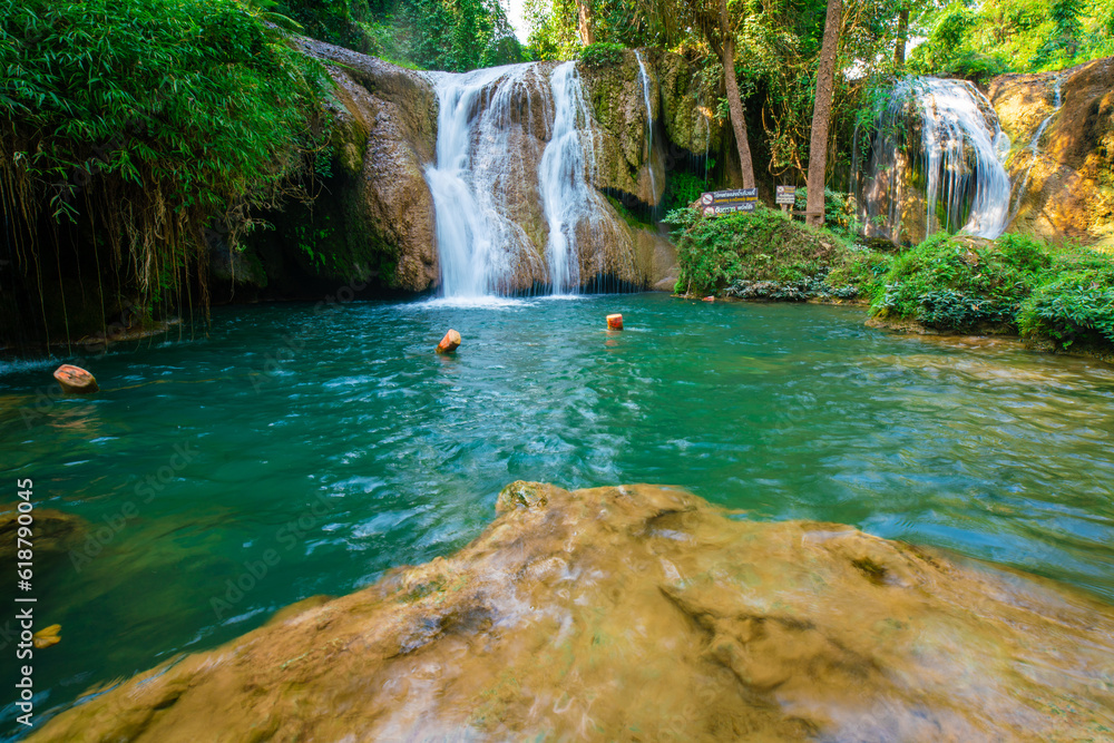 Naklejka premium Waterfall in tropical rainforest with green tree forest in Phayao north of Thailand